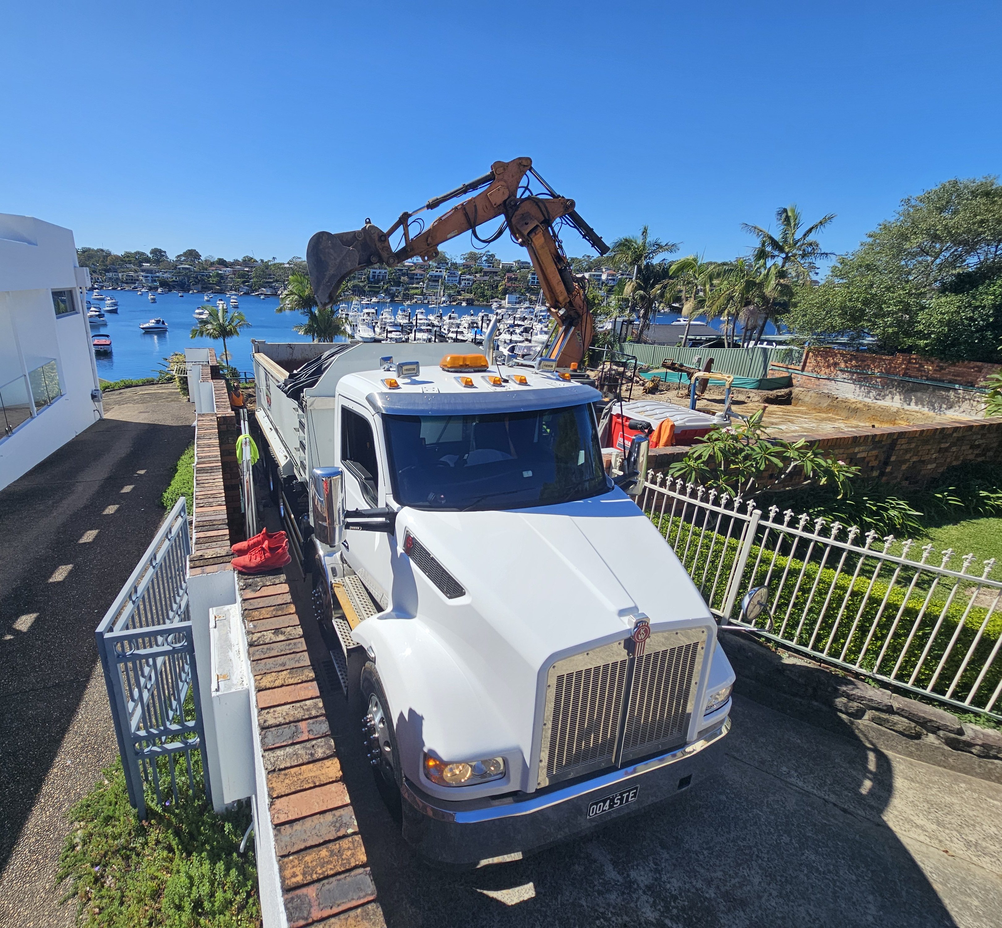 10-Wheeler tipper truck being loaded with excavated soil on site.